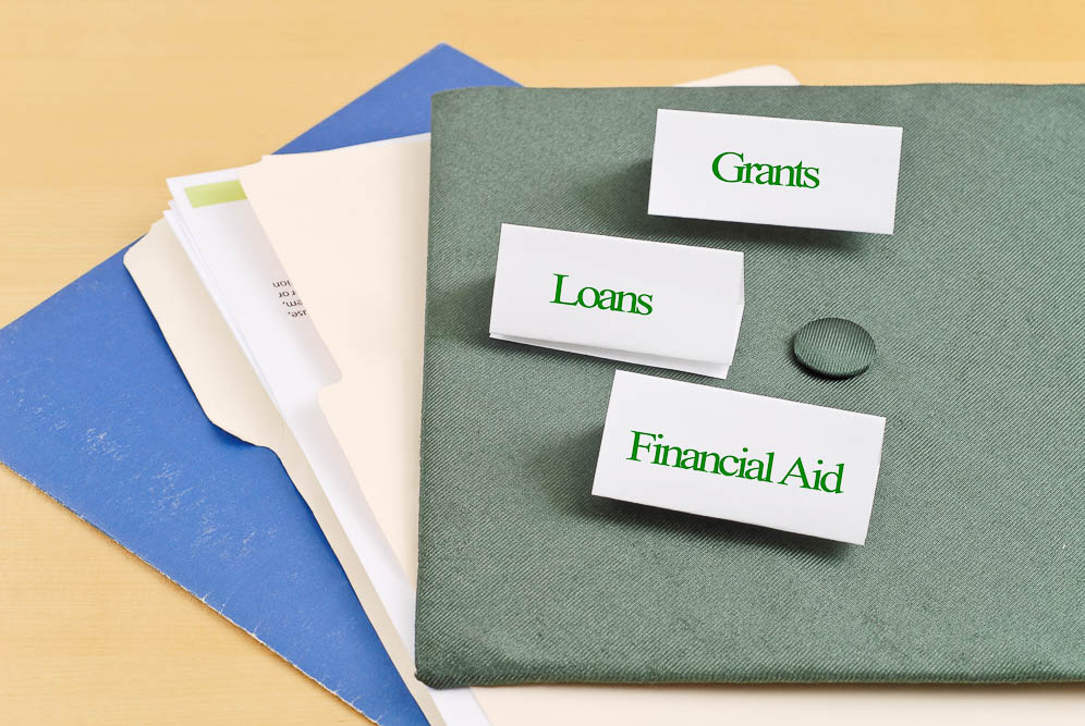 folders on a table with lables that say grants loans and financial aid